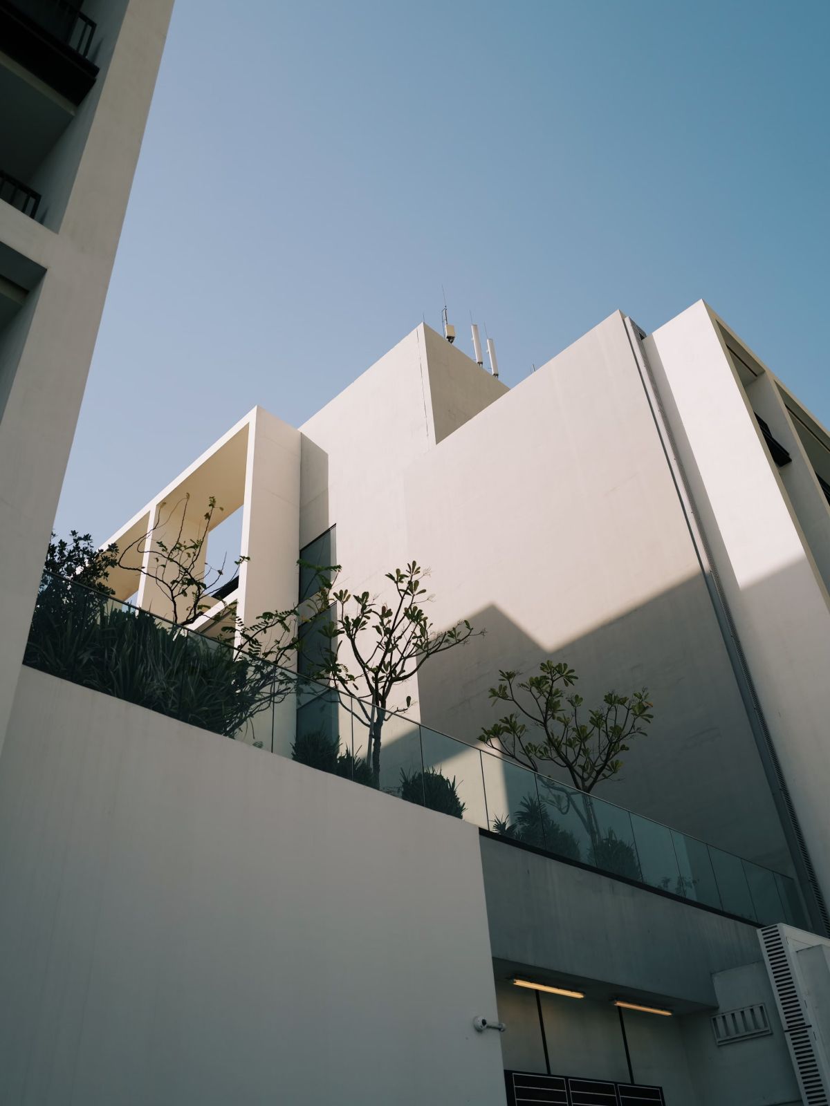 a white, flat-roofed, modern building